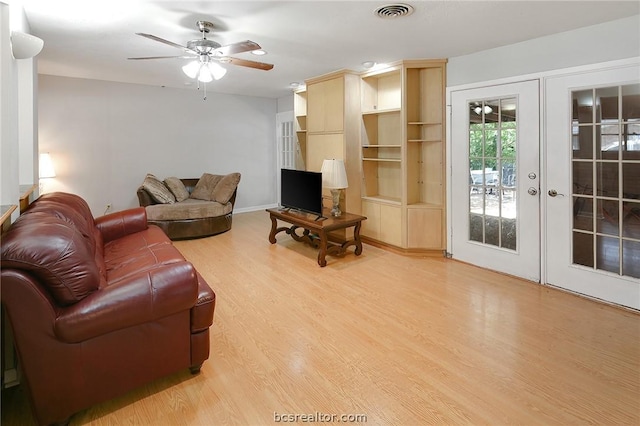 living room with ceiling fan, light hardwood / wood-style flooring, and french doors