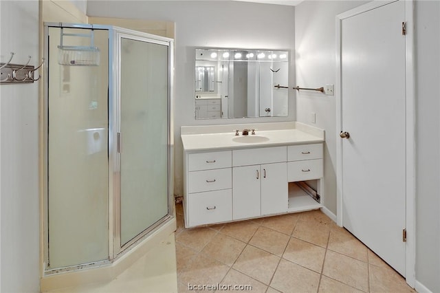 bathroom featuring tile patterned floors, vanity, and a shower with door