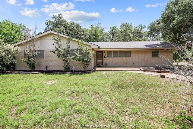 back of property featuring a lawn and a patio area