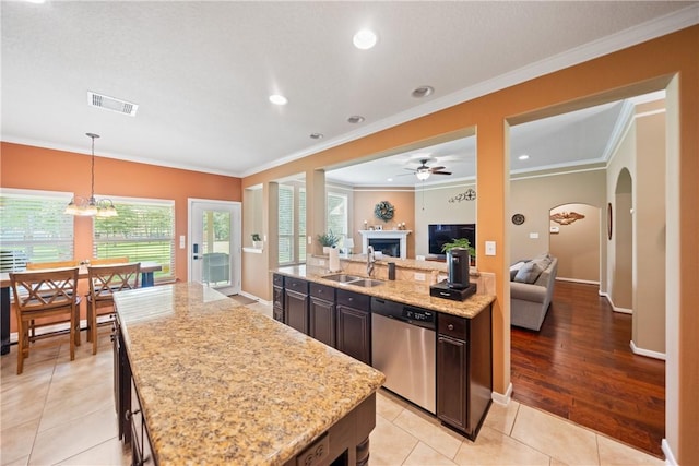 32041 Fm 1736th Rd, Hempstead, TX 77445 - kitchen with stainless steel dishwasher, a sink, a kitchen island, open floor plan, and crown molding