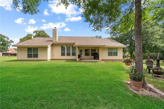 32041 Fm 1736th Rd, Hempstead, TX 77445 - back of house with a lawn and a chimney