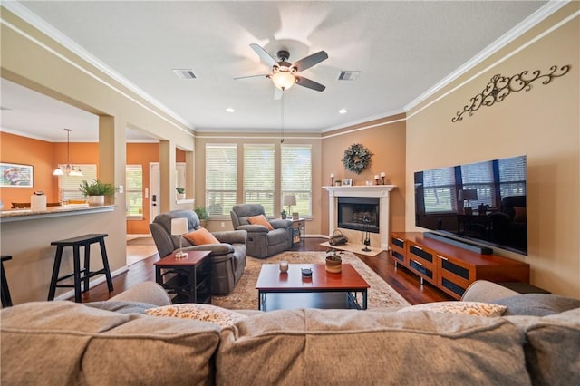 32041 Fm 1736th Rd, Hempstead, TX 77445 - living room featuring wood finished floors, ceiling fan, ornamental molding, a fireplace with flush hearth, and recessed lighting