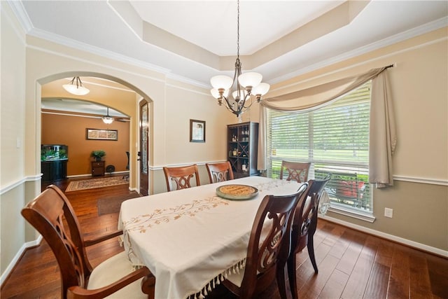 32041 Fm 1736th Rd, Hempstead, TX 77445 - dining room with arched walkways, a chandelier, dark wood-style floors, a raised ceiling, and baseboards