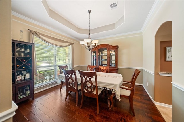 32041 Fm 1736th Rd, Hempstead, TX 77445 - dining space with a chandelier, arched walkways, a raised ceiling, ornamental molding, and hardwood / wood-style floors