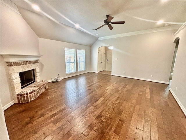 unfurnished living room featuring ceiling fan, lofted ceiling, wood-type flooring, and a stone fireplace