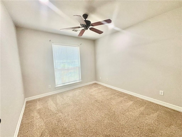 carpeted empty room with ceiling fan