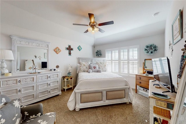 carpeted bedroom with ceiling fan and lofted ceiling