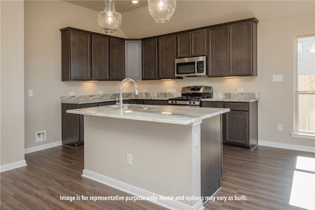 kitchen featuring dark hardwood / wood-style flooring, stainless steel appliances, light stone counters, and dark brown cabinetry