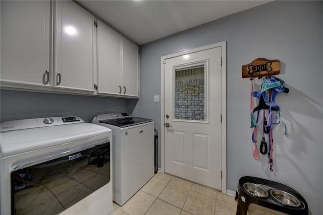 1600 Pecan St, Brenham, TX 77833 - laundry area featuring cabinet space, washer and dryer, light tile patterned floors, and baseboards