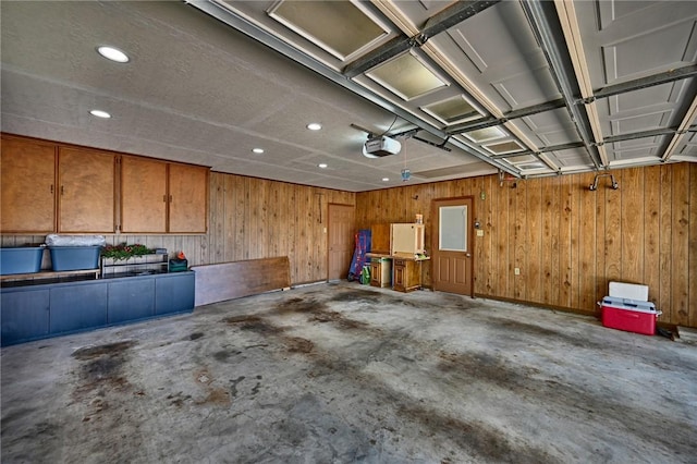 1600 Pecan St, Brenham, TX 77833 - garage with a garage door opener, recessed lighting, and wooden walls