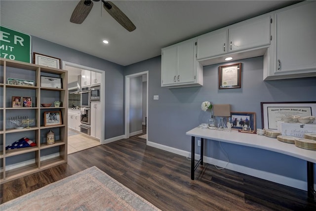 1600 Pecan St, Brenham, TX 77833 - kitchen featuring dark wood-style floors, stainless steel microwave, ceiling fan, baseboards, and light countertops