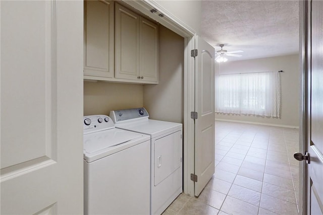 washroom featuring cabinet space, a ceiling fan, light tile patterned floors, and washing machine and clothes dryer