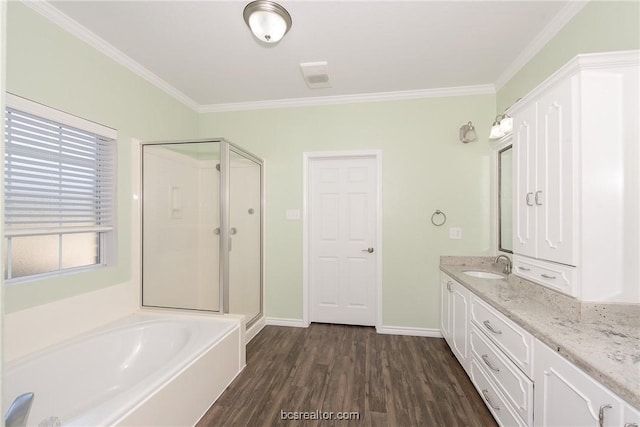 bathroom with hardwood / wood-style floors, vanity, independent shower and bath, and ornamental molding