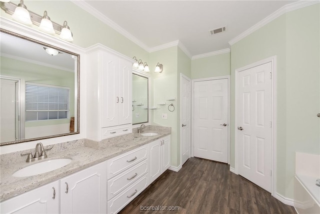 bathroom featuring wood-type flooring, vanity, and crown molding