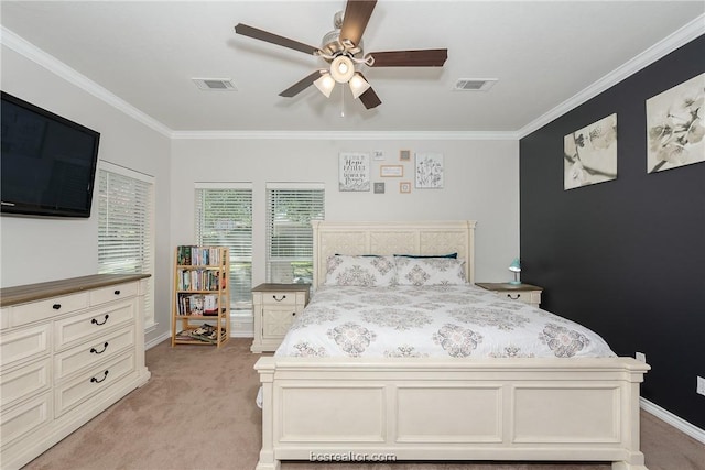 carpeted bedroom featuring ceiling fan and crown molding