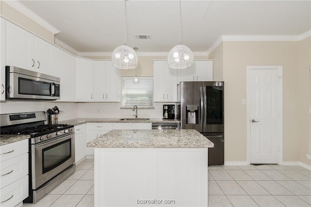 kitchen with pendant lighting, a center island, sink, appliances with stainless steel finishes, and white cabinetry