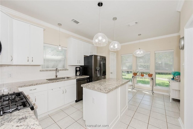 kitchen featuring white cabinets, pendant lighting, a kitchen island, and sink