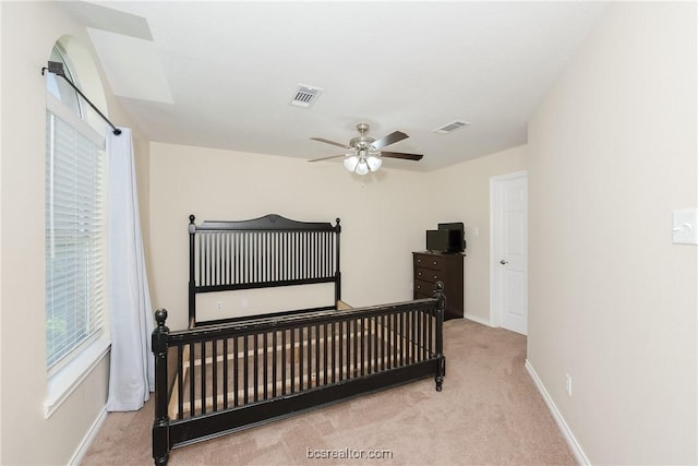 bedroom with light carpet and ceiling fan