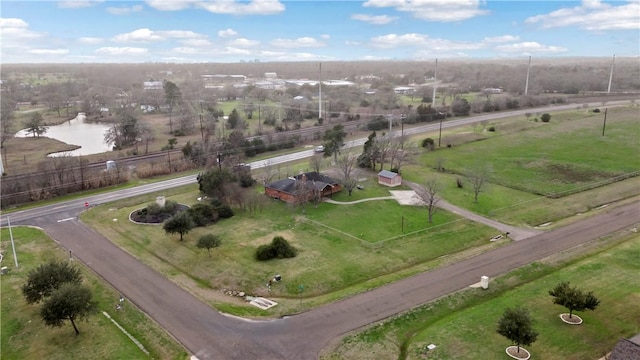 birds eye view of property with a rural view and a water view