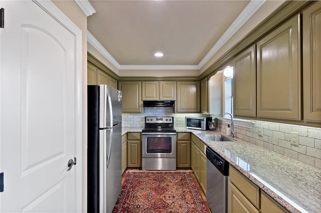 kitchen with decorative backsplash, stainless steel appliances, crown molding, under cabinet range hood, and a sink