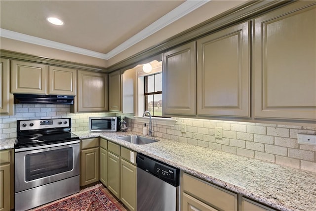 kitchen featuring under cabinet range hood, a sink, ornamental molding, appliances with stainless steel finishes, and decorative backsplash