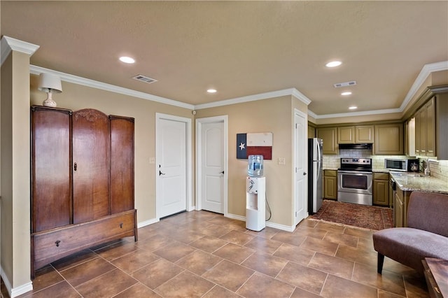 kitchen featuring under cabinet range hood, appliances with stainless steel finishes, visible vents, and tasteful backsplash