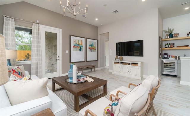 living area featuring light wood-style flooring, wine cooler, visible vents, and recessed lighting