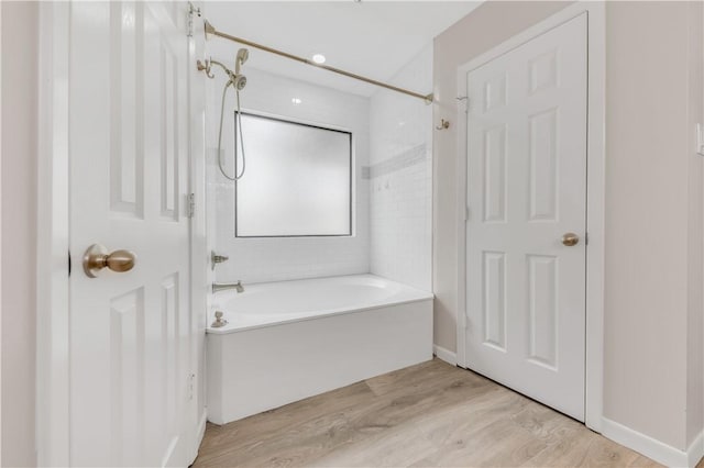 8118 Butler Ridge Dr, College Station, TX 77845 - bathroom featuring washtub / shower combination and wood finished floors