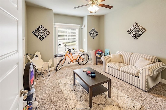 living room with ceiling fan and baseboards