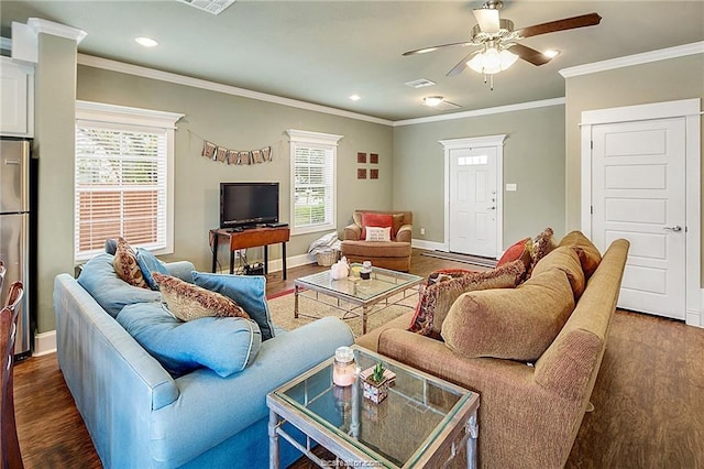 living room featuring dark wood-type flooring, a wealth of natural light, and baseboards