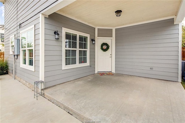 property entrance featuring a patio