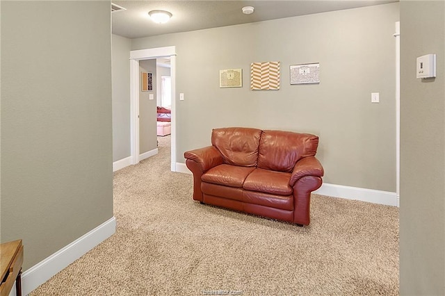 carpeted living room featuring visible vents and baseboards