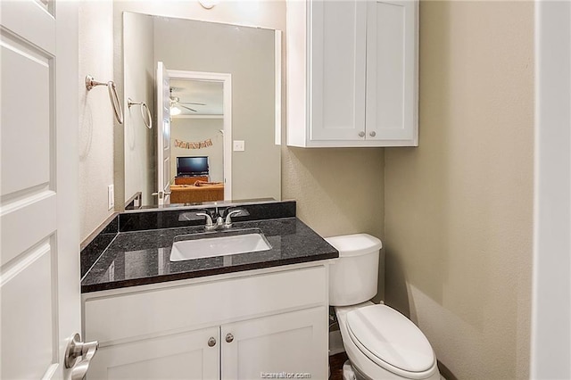 ensuite bathroom with toilet, connected bathroom, and vanity