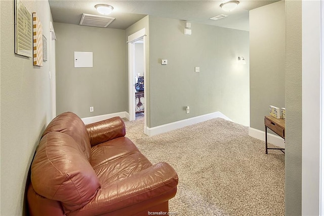 living area with carpet, visible vents, and baseboards