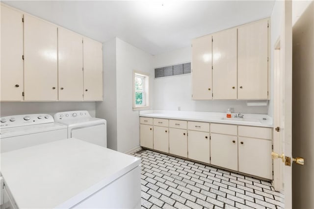 501 College View Dr, Bryan, TX 77801 - laundry area with cabinet space, separate washer and dryer, brick patterned floors, and baseboards