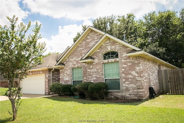 view of front of home featuring a front yard and a garage