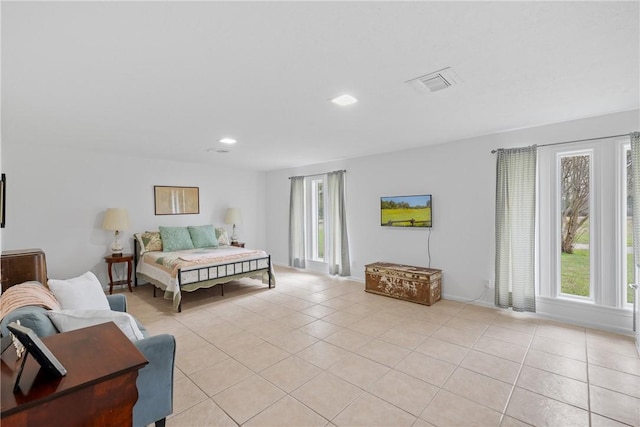 bedroom featuring light tile patterned flooring, baseboards, and visible vents