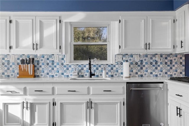 kitchen with dishwasher, white cabinetry, light countertops, and a sink