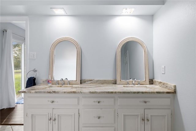 bathroom featuring a sink and double vanity