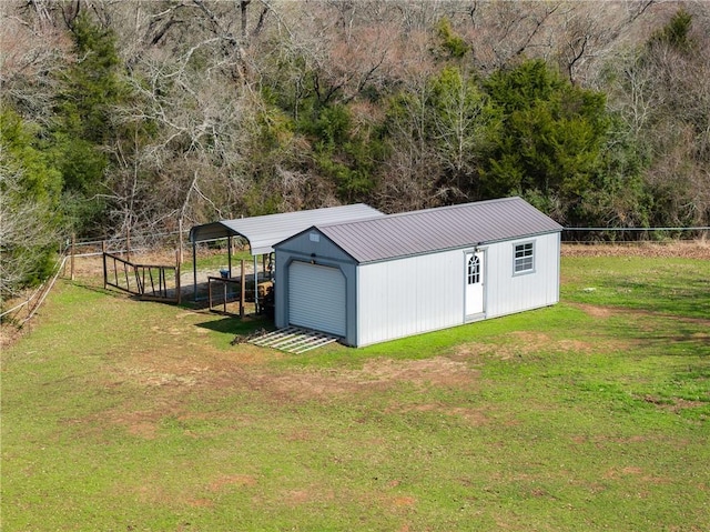 view of outbuilding featuring an outbuilding, fence, and a carport