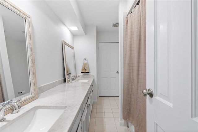 full bathroom featuring a sink, double vanity, and tile patterned floors