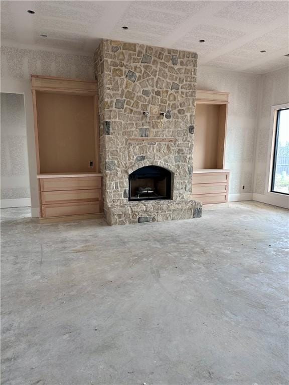 unfurnished living room with a fireplace and unfinished concrete floors