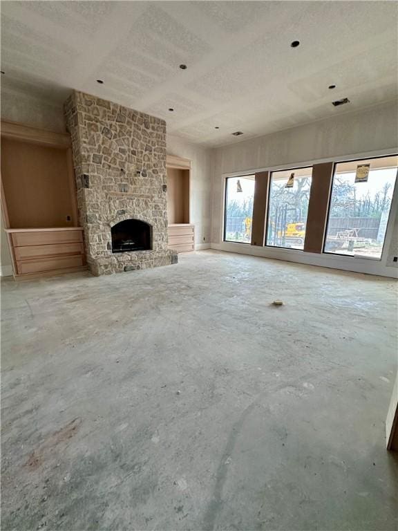 unfurnished living room with concrete floors, a fireplace, and visible vents