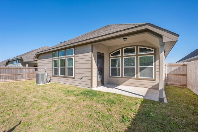 back of property featuring a fenced backyard, central AC unit, a patio area, and a lawn