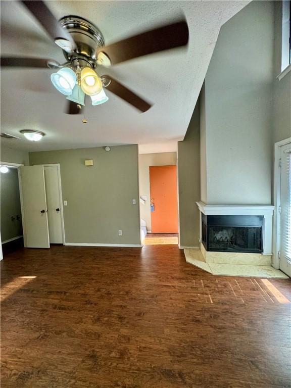 unfurnished living room featuring ceiling fan and a healthy amount of sunlight