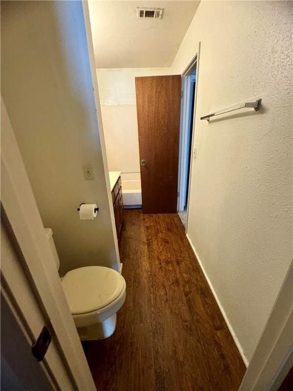 bathroom with vanity, wood-type flooring, and toilet