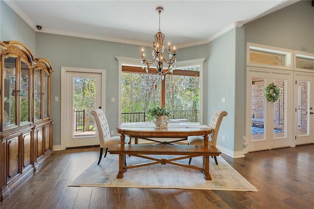 5395 Stirrup Dr, College Station, TX 77845 - dining area with a chandelier, plenty of natural light, dark wood-style flooring, crown molding, and baseboards