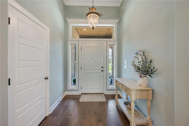 5395 Stirrup Dr, College Station, TX 77845 - foyer entrance with dark wood-style flooring, crown molding, and baseboards