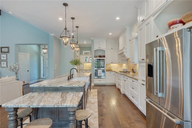 5395 Stirrup Dr, College Station, TX 77845 - kitchen with appliances with stainless steel finishes, open shelves, white cabinets, dark wood-type flooring, and recessed lighting