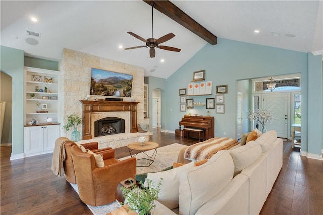 5395 Stirrup Dr, College Station, TX 77845 - living room featuring arched walkways, dark wood-style flooring, ceiling fan, beamed ceiling, and a fireplace